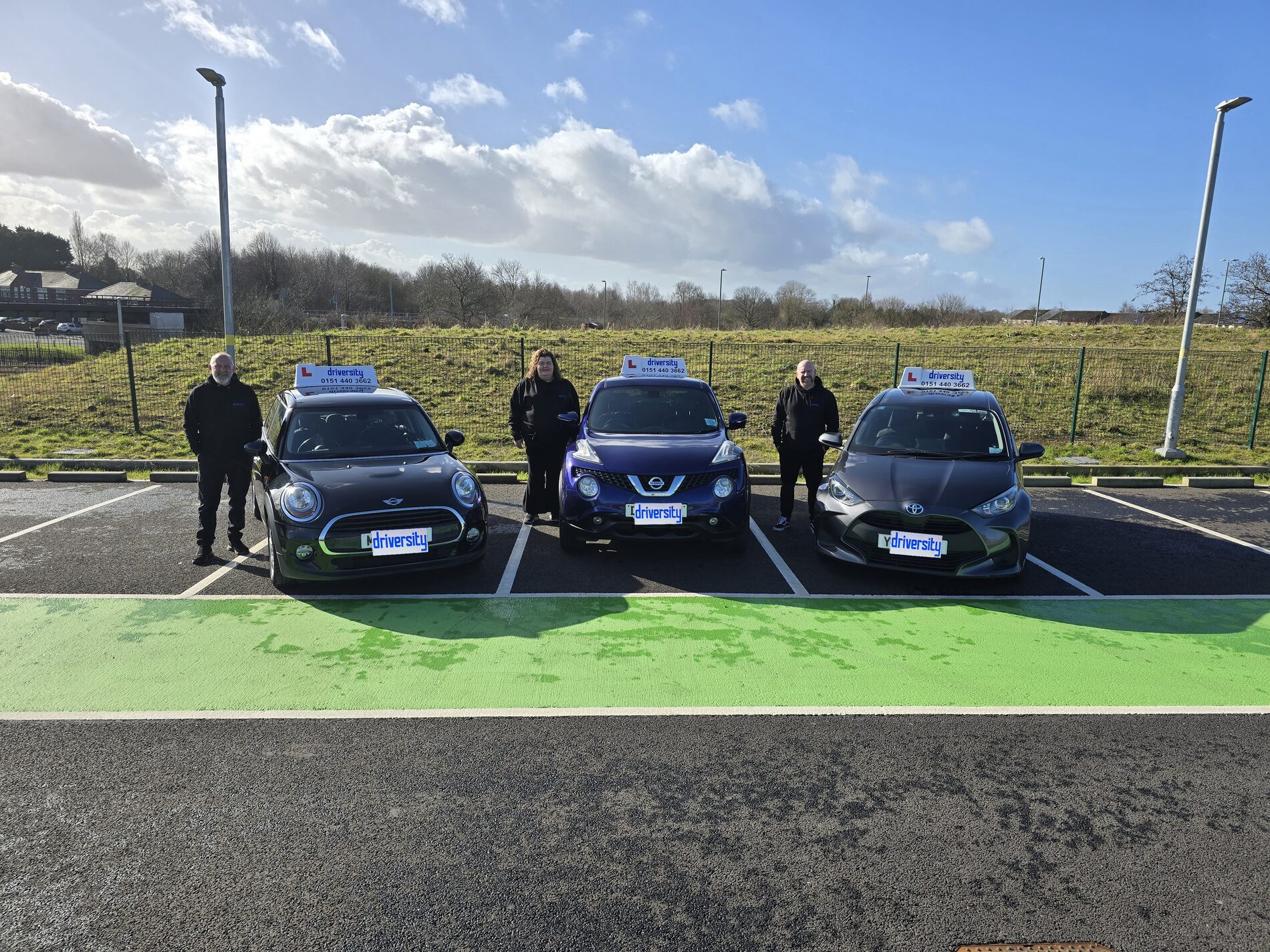 The Driversity team with their branded driving school cars
